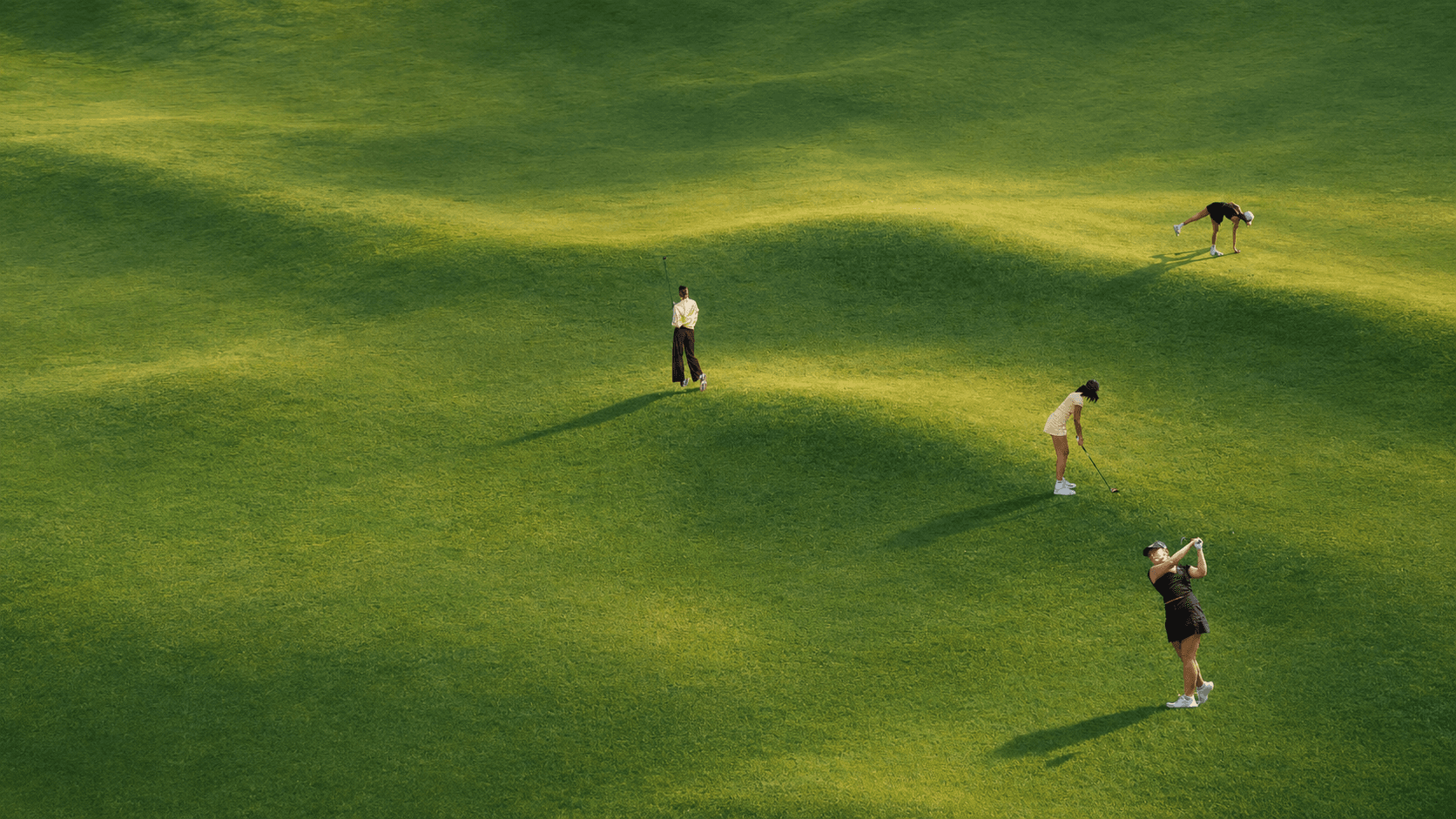 Golfers on a sunlit course
